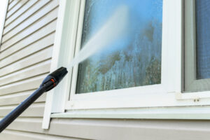 Trusted window cleaning specialists in Vancouver Cleaning service washing building facade and window with pressure water. Cleaning dirty wall with high pressure water jet. Power washing the wall. Cleaning the facade of the house. Before and after.